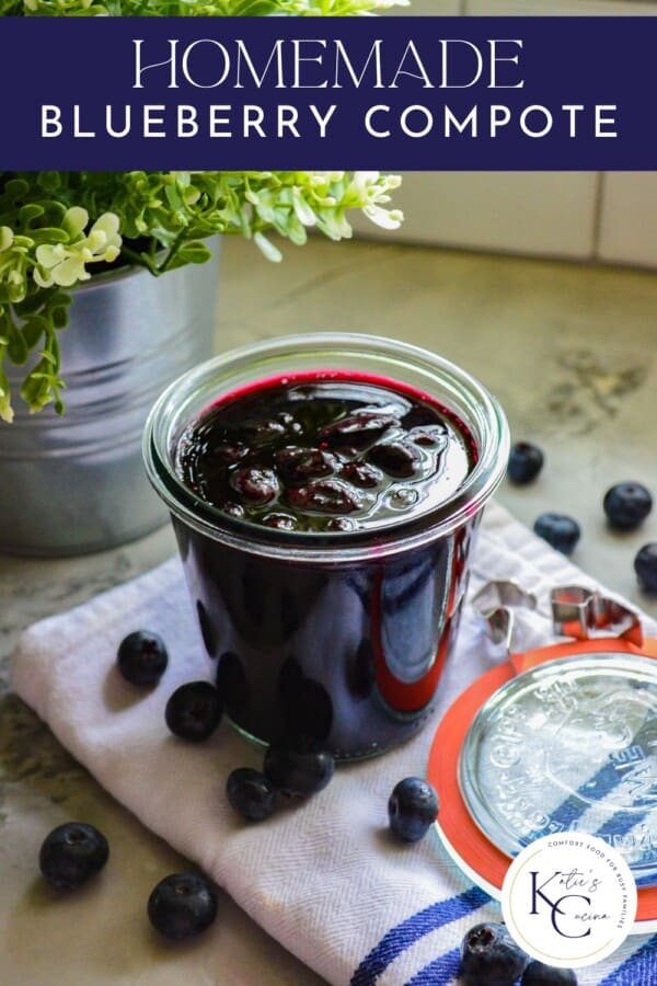 Glass jar with blueberry sauce on a white cloth with fresh blueberries with recipe title text on image for Pinterest.