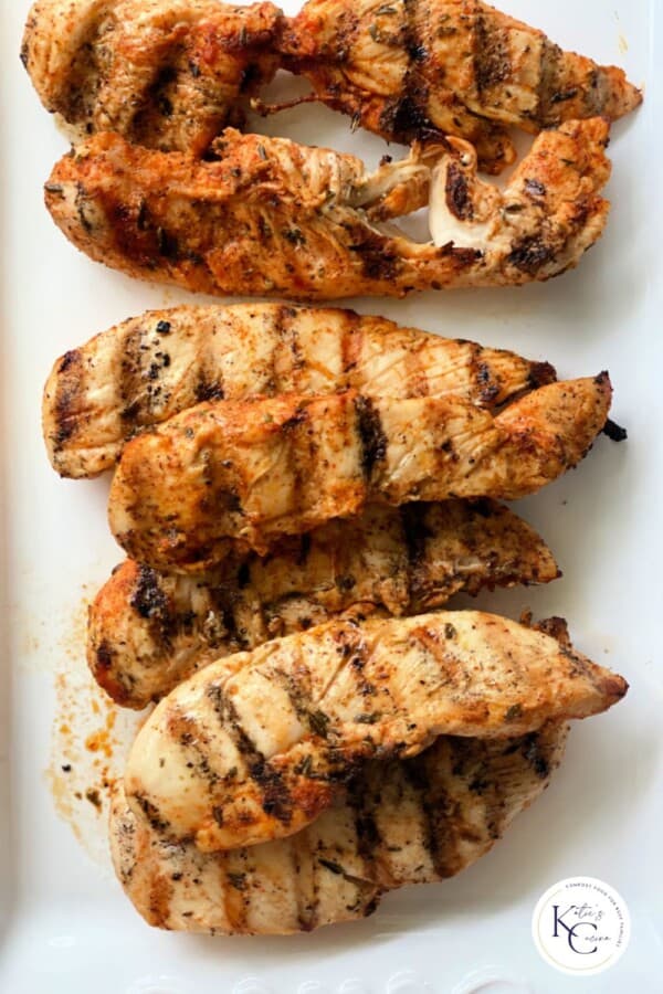 White platter with seven grilled chicken strips and logo on right bottom corner.