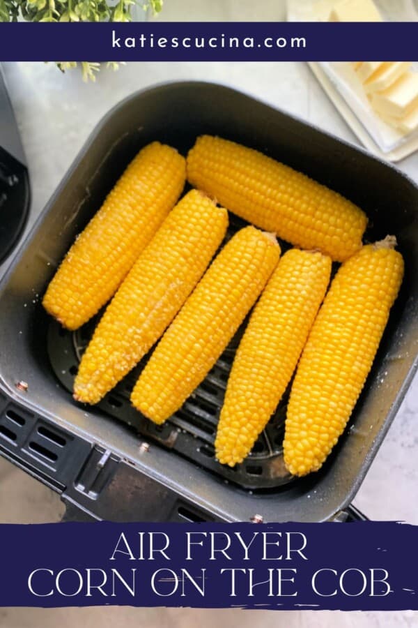 Text on image: "air fryer corn on the cob" with photo of Black Air Fryer basket with 6 corn on the cobs inside the basket.