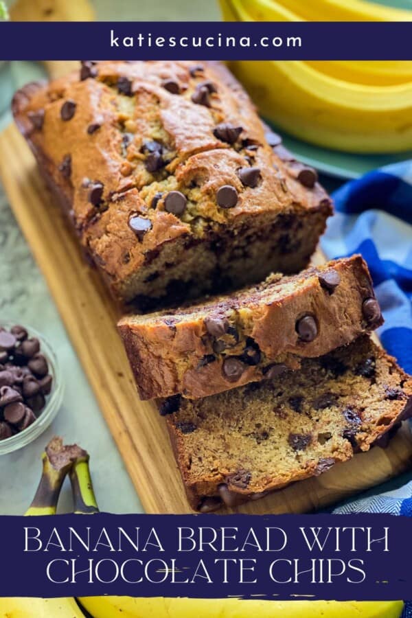 Banana bread with chocolate chips loaf on a cutting board with slices cut from it.