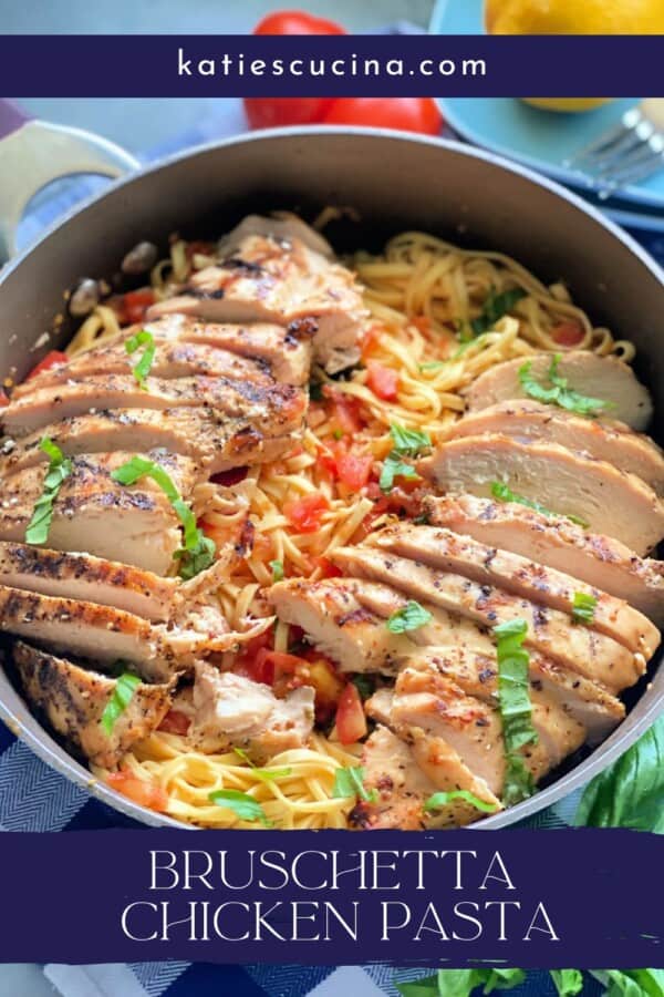 Brown skillet filled with pasta with tomatoes and basil with sliced grilled chicken breast on top and recipe title text for Pinterest on image.