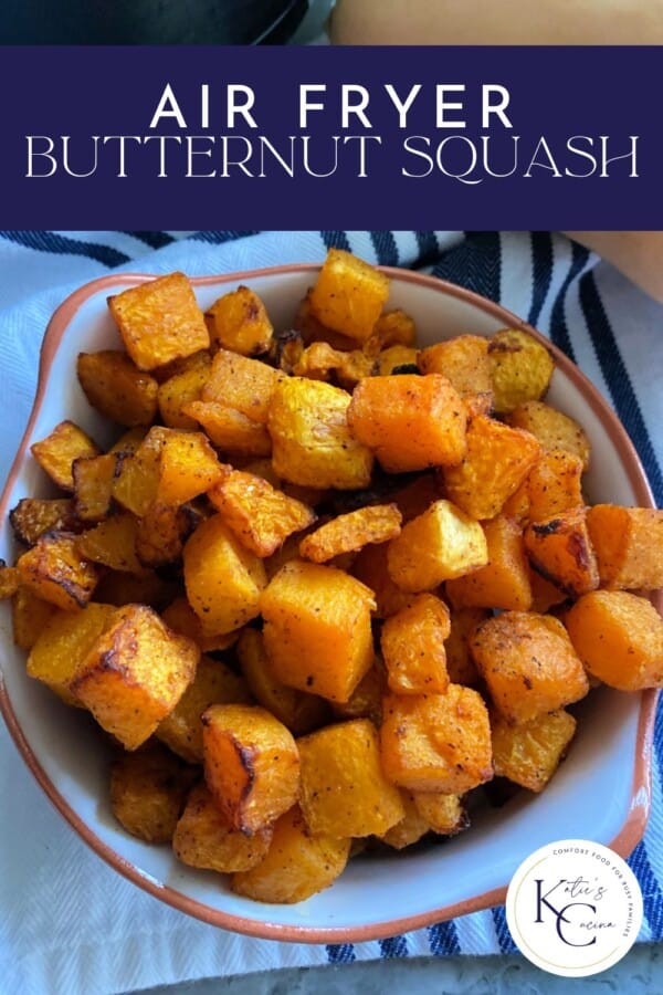 Text on image: "air fryer butternut squash" with photo of air fryer butternut squash in a dish on a blue and white striped cloth.
