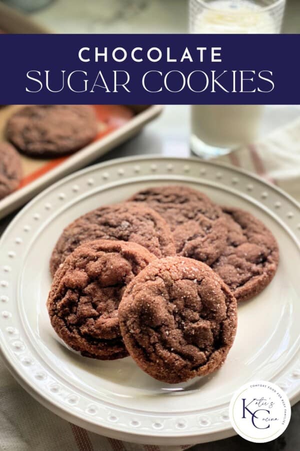 Text on image: "chocolate sugar cookies" with photo of 5 chocolate sugar cookies on a white plate with a pink striped white cloth in the background with a glass of milk and 2 baked cookies on a cookie sheet.