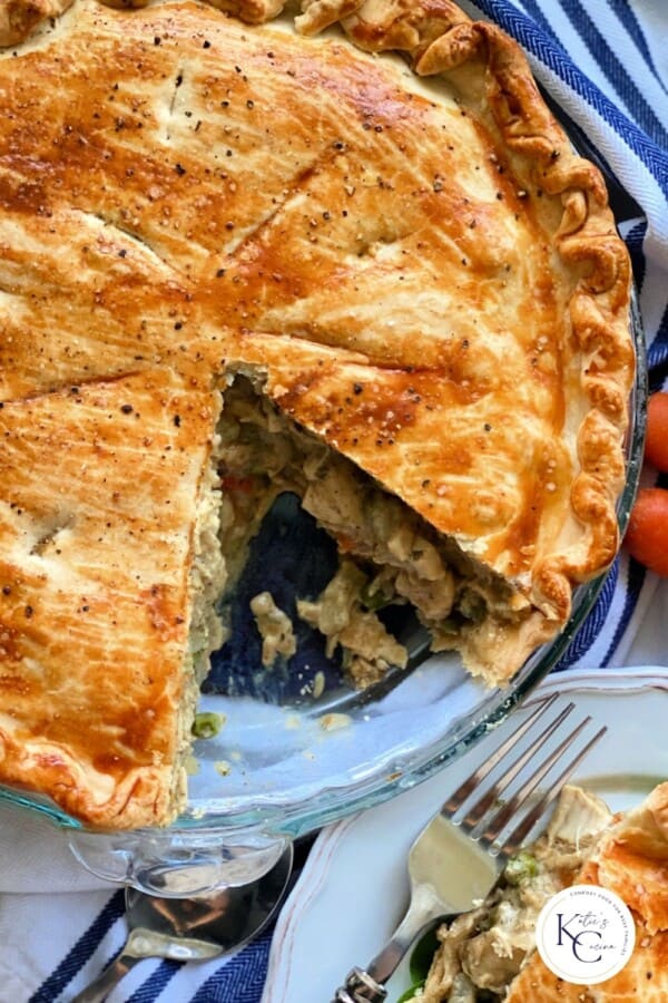 A pie with savory filling with a logo on the bottom right corner.