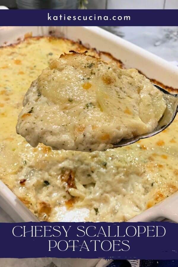 Spoonful of Cheesy Scalloped Potatoes form casserole dish with Pinterest text.