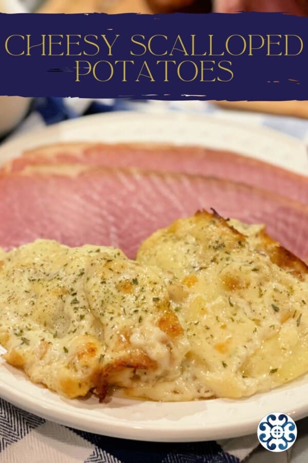 Cheesy Scalloped Potatoes and sliced ham on white plate with Pinterest text.
