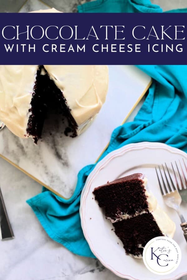 Slice of chocolate cake with cream cheese frosting on a white plate with blue table runner with the whole cake with Pinterest text.