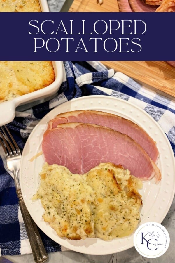 Cheesy scalloped potato with sliced ham on a white dish with Pinterest text.