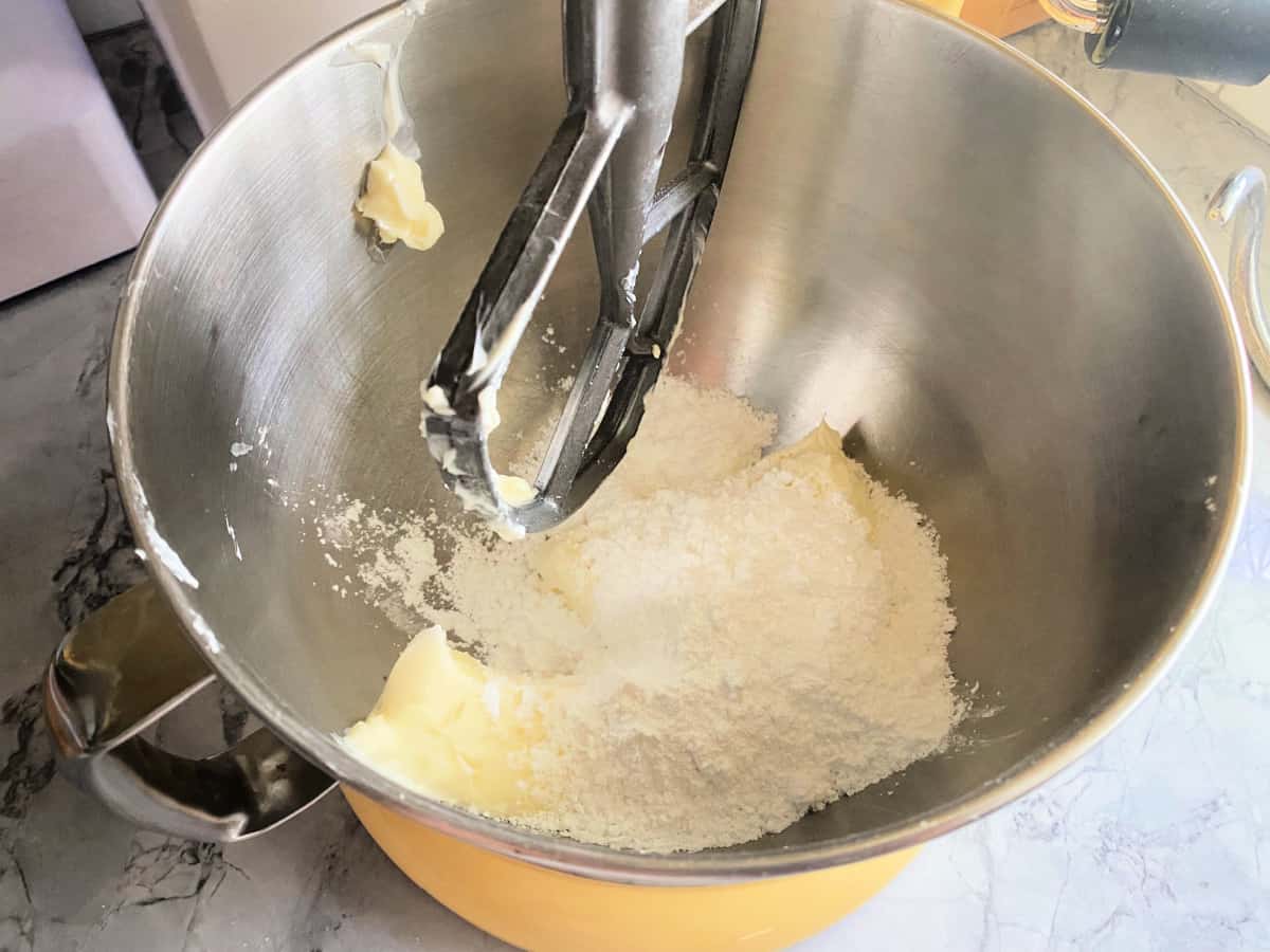Cream cheese frosting ingredients inside KitchenAid mixer.