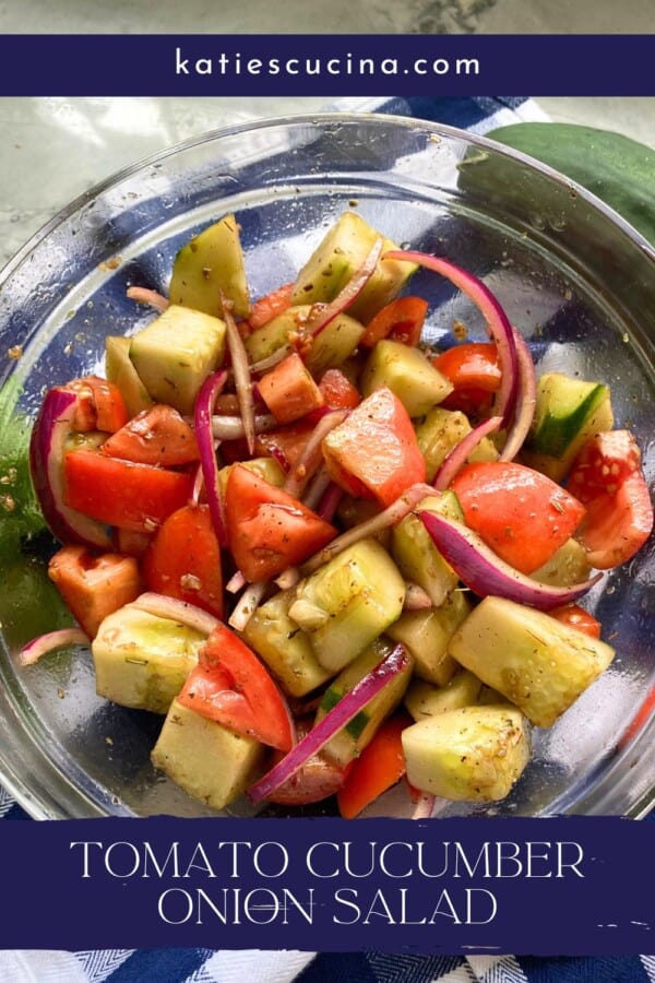 Glass bowl filled with cucumber, tomatoes, and red onions with text on image for Pinterest.