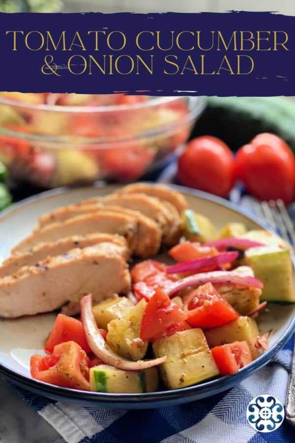 Plate with cucumber tomato salad with grilled chicken with text on image for Pinterest.