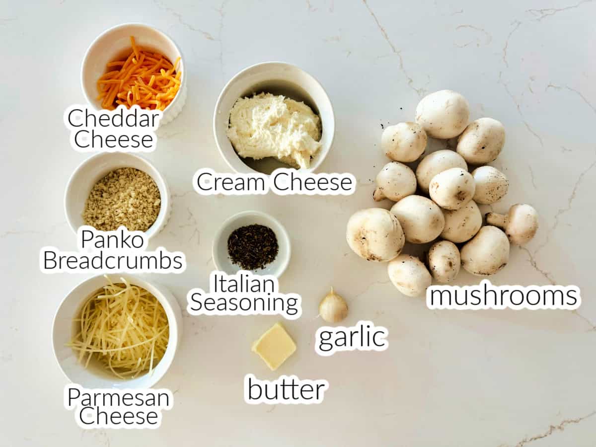 Ingredients on counter: shredded cheese, panko breadcrumbs, cream cheese, italian seasoning, butter, garlic, and mushrooms.