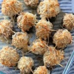 Glass dish filled with baked stuffed mushrooms.