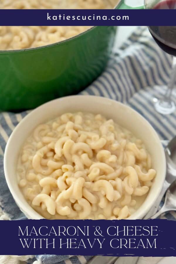 White bowl filled with mac and cheese on a striped cloth with red wine glass next to it with text on image for Pinterest.