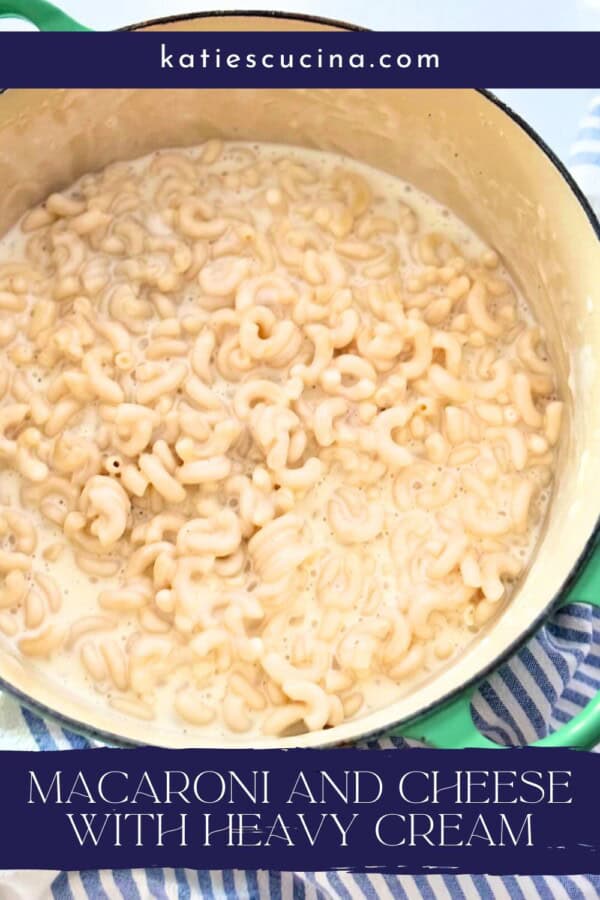 White elbow mac and cheese in a large pot on a striped cloth with text on image for Pinterest.