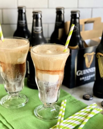 Two glasses filled with ice cream and beer.