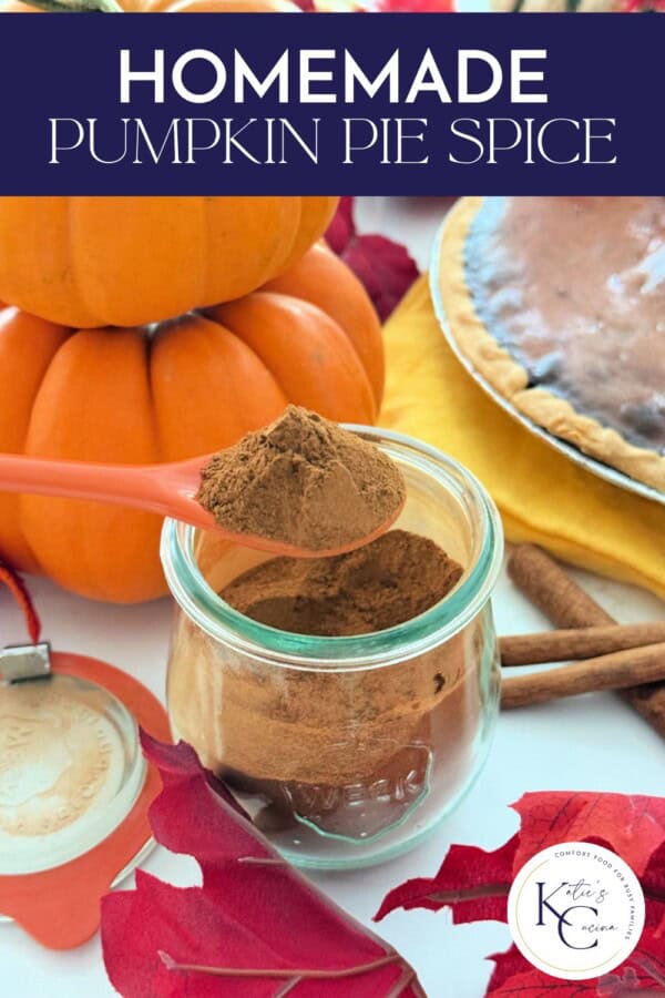 Glass jar with orange spoon scooping out brown spice with text on image for Pinterest.